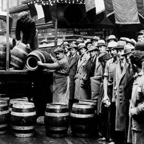 A crowd gathers as kegs of beer are unloaded in front of a restaurant on Broadway in New York City, the morning of April 7, 1933, when low-alcohol beer is legalized again.  (AP Photo)